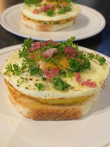 a sandwich on a white plate on a table at Mansion9Bruges in Bruges