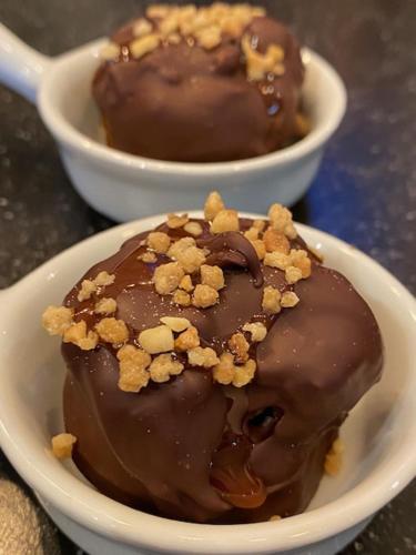 two bowls of chocolate covered nuts on a table at Mansion9Bruges in Bruges