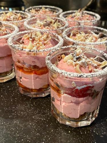 a row of plastic cups filled with pink desserts at Mansion9Bruges in Bruges