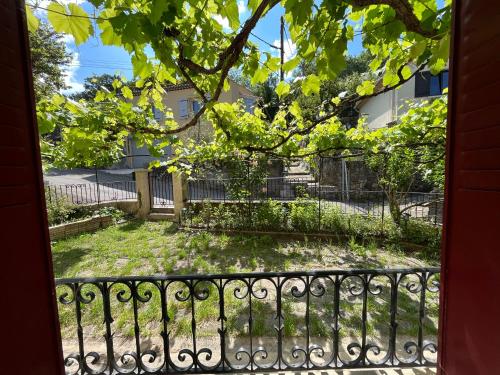 a balcony with a fence and a tree at Maison La vieille vigne in Dieulefit
