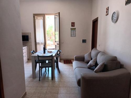 a living room with a couch and a table at La Mimosa Case Vacanze in Marsala