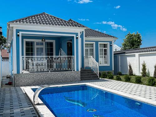 a house with a swimming pool in front of a house at Qafqaz Magnolia Harmony in Gabala