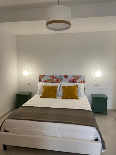 a bedroom with a large bed with yellow pillows at Casale Conti in Castellabate