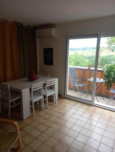 d'une salle à manger avec une table et une porte coulissante en verre. dans l'établissement Location saisonnière par nuitée, à Duran