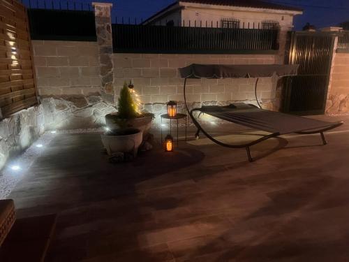 a patio at night with a table and a plant at La Casita de Yuncos in Yuncos