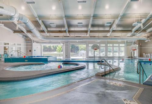 a large indoor swimming pool with blue water at Hilton Vacation Club Beachwoods Kitty Hawk in Kitty Hawk