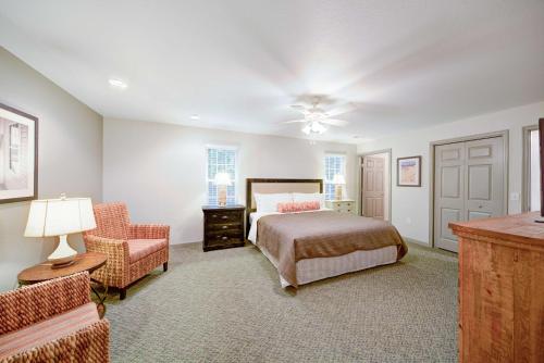 a bedroom with a bed and a chair at Hilton Vacation Club Beachwoods Kitty Hawk in Kitty Hawk