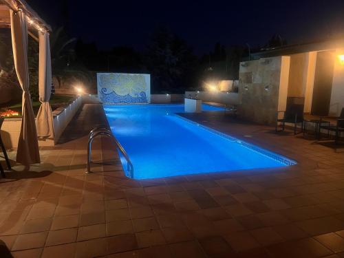 a swimming pool at night with blue lighting at La Casita de Yuncos in Yuncos