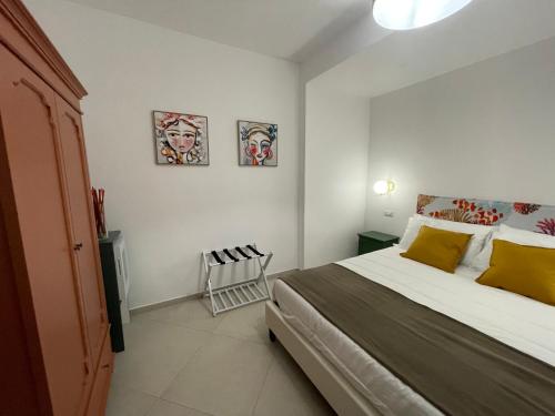 a bedroom with a bed and two pictures on the wall at Casale Conti in Castellabate