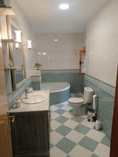 a bathroom with a sink and a toilet and a tub at Aires Del Ambroz in Casas del Monte