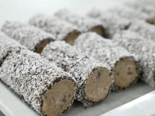 a tray of chocolate and powdered sugar covered desserts at LH Albergo il Picchio in Pescasseroli