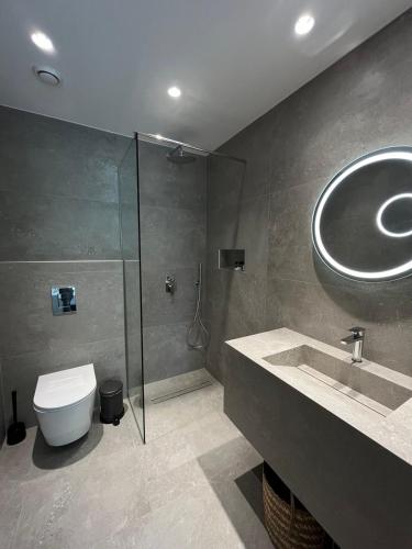 a bathroom with a toilet and a sink and a shower at Abacus Suites in Ayia Napa