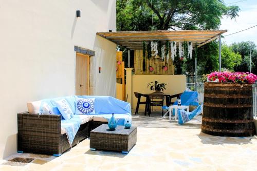 a living room with a couch and a table with a table at Linos House in Avliótai