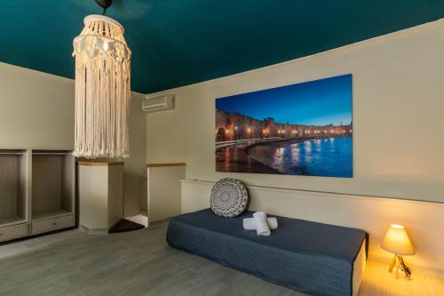 a bedroom with a bed and a painting on the wall at Lefka Hotel & Apartments in Rhodes Town