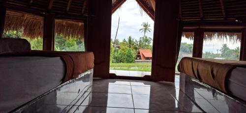 a room with two chairs and an open door at Uma Nirmala Aling-Aling in Singaraja