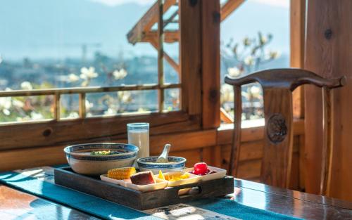 a tray of food sitting on top of a table at Lijiang Zen Garden Hotel in Lijiang
