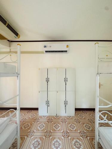 a room with two bunk beds and a wall at Guesthouse Station in Bangkok
