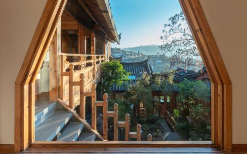 an open window with a view of a building at Lijiang Zen Garden Hotel in Lijiang
