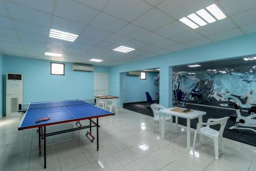 a room with a ping pong table and chairs at Barracuda Resort in Umm Al Quwain