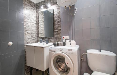 a bathroom with a washing machine and a toilet at PANORAMIC VIEW Playa Paraíso in Adeje