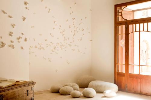 a room with a bunch of butterflies on the wall at S'Hotelet de Santanyi in Santanyi