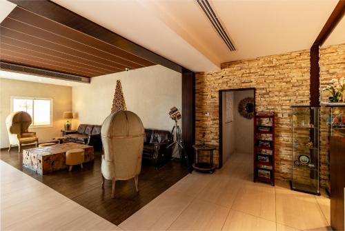 a living room with a couch and a brick wall at Barracuda Resort in Umm Al Quwain