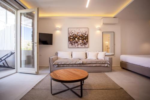 a living room with a couch and a table at VILLA PANAMERA Mykonos, Private Heaven, Supreme View! in Fanari