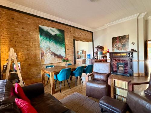 a living room with a couch and a table with chairs at THE PLACE Muizenberg in Muizenberg