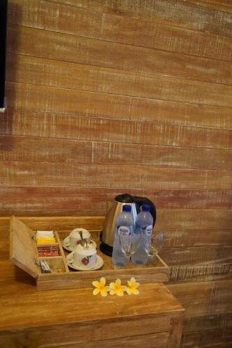 a table with two glasses and a tea kettle at LASTANA SUITE UBUD in Ubud