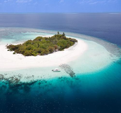 an island in the ocean with a boat in it at Ostrov Palm in Ukulhas