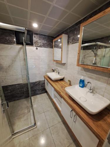a bathroom with two sinks and a shower at Villa Nimo 5 plus 1 for Rent with Private Pool in Antalya
