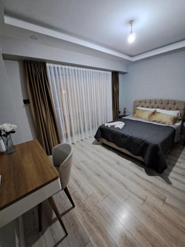 a bedroom with a bed and a table and a desk at Villa Nimo 5 plus 1 for Rent with Private Pool in Antalya