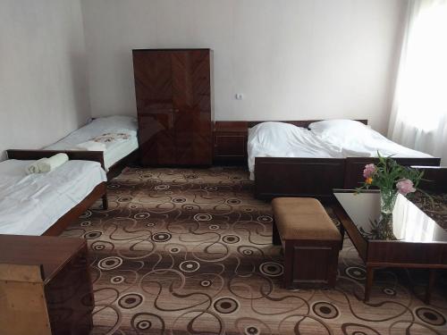 a small room with two beds and a table and a table sidx sidx at GALA Guesthouse in Alaverdi