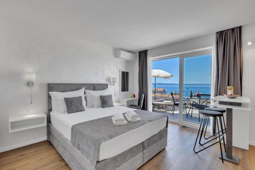a bedroom with a bed and a view of the ocean at Apartments Dany in Makarska