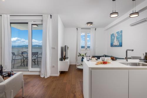a kitchen and living room with a view of the ocean at Luxury apartment Mon Soleil 2 in Murter
