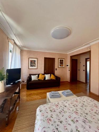 a living room with a bed and a couch at Residenza Vernato in Biella