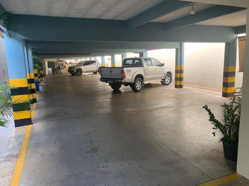 a parking garage with a truck parked in it at Hotel Tropical in Porto Velho
