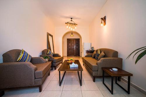 a living room with couches and a coffee table at Umm Al Quwain Beach Hotel in Umm Al Quwain