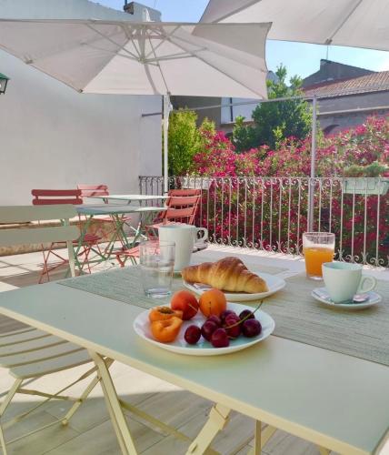 a white table with a plate of food on it at Il Giardino Nascosto B&B in Vasto
