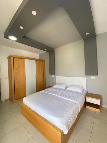 a bedroom with a large bed with white sheets at Jasmine Resort & Aqua park in Sharm El Sheikh