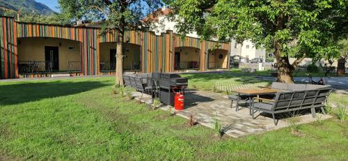a patio with a table and chairs and a grill at Stadlchalet in Ried im Oberinntal