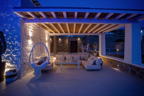 a living room with a couch and a swing at VILLA PANAMERA Mykonos, Private Heaven, Supreme View! in Fanari