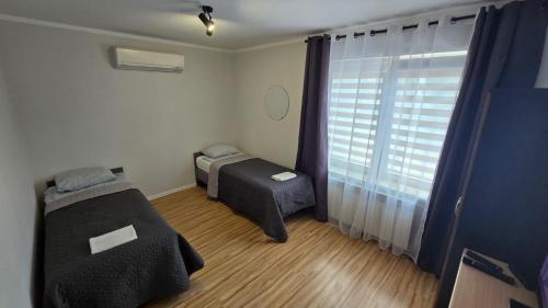 a small room with a bed and a window at SKY BLUE LOQUS Studia i Apartmenty in Płock