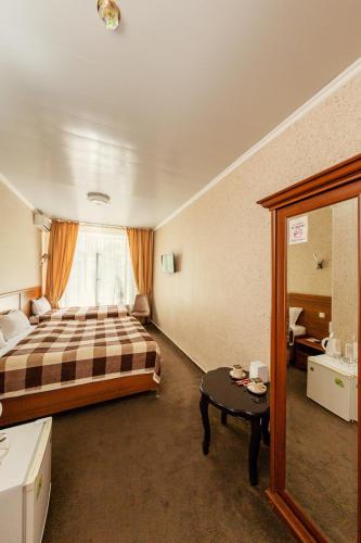 a hotel room with a bed and a table at Ajour in Almaty