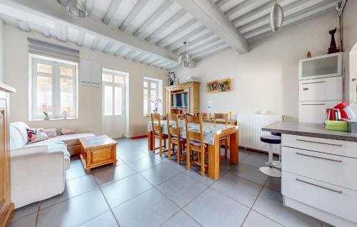 a kitchen and living room with a table and chairs at Awesome Home In Arques La Bataille in Arques-la-Bataille