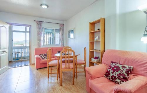 a living room with a couch and a table and chairs at 2 Bedroom Beautiful Home In Castalla in Castalla