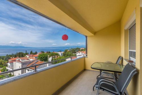 a balcony with a table and chairs and a view at Apartmani Tena in Njivice