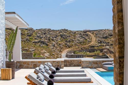 a villa with a view of a hill and a pool at VILLA PANAMERA Mykonos, Private Heaven, Supreme View! in Fanari