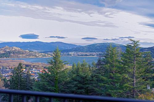 a view of a city and a body of water at Hotel Hita "Nature Experience" for all in Navacerrada