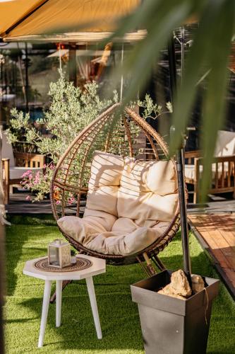 a swinging chair in a garden with a plant at Morena in Ulcinj